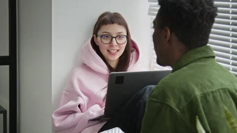 Caucasian Female Programmer Chatting to Black Male Colleague by Window Video stock 335938416