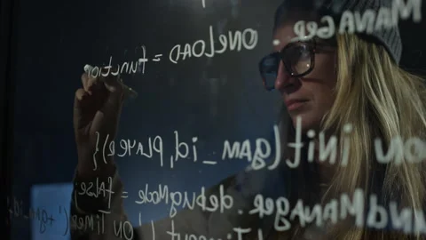 Caucasian Female Programmer Writing Computer Code on Glass Wall in Office Stock Footage 273833872