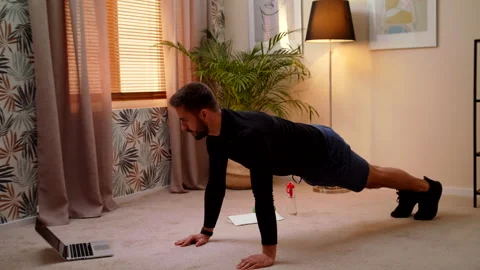 Caucasian Fit Man Doing Push-Ups Exercises At Home While Watching Sport Video Stock Footage 145244322