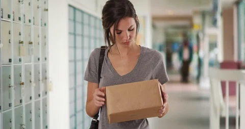 Caucasian girl checking package before heading to post office in post office Stock Footage 87627784