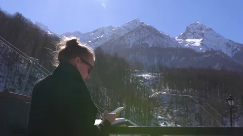 Caucasian girl communicates using touchscreen phone against mountain view Video stock 80144482