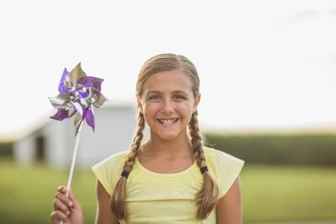 Caucasian girl holding pinwheel on farm Stock Photos
