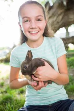 Caucasian girl holding rabbit Stock Photos