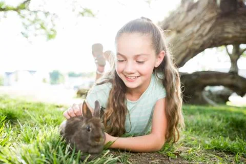 Caucasian girl petting rabbit Stock Photos
