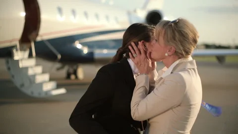 Caucasian girl showing first place ribbon to grandmother near private jet Stock Footage