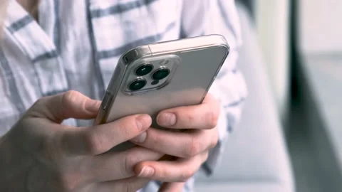 Caucasian Girl using iPhone 12 smartphone pressing finger, reading social media Stock-Footage 201874148