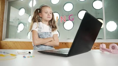 Caucasian girl using laptop programing software while crossing arms. Erudition. Stock Photos