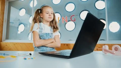 Caucasian girl using laptop programing software while crossing arms. Erudition. Stock Photos
