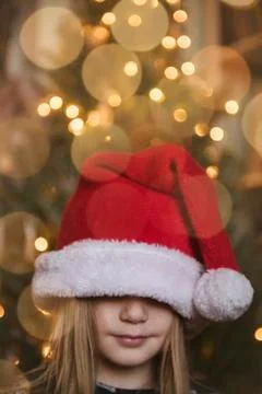 Caucasian girl wearing large Santa hat Stock Photos