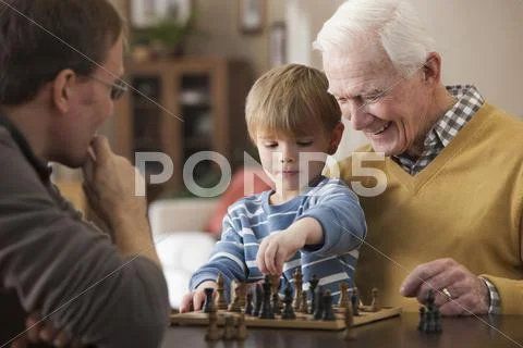 Caucasian grandfather and grandson playing chess Stock Photos