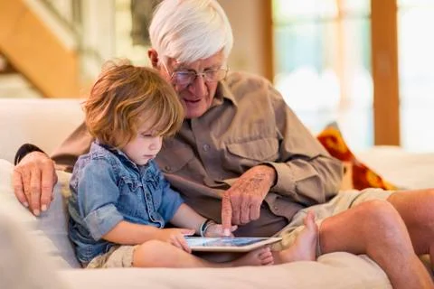Caucasian grandfather and grandson using digital tablet 스톡 사진