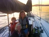 Caucasian grandmother and grandchildren on sailboat Stock Photos