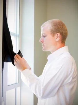 Caucasian groom checking his jacket, getting ready for his weddi Stock Photos