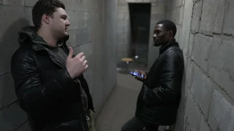 Caucasian guy and black guy are standing in a bombproof shelter during a Stock Footage 171347619