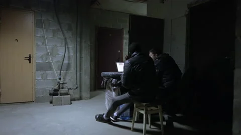 Caucasian guy and black guy are sitting near open laptop with the latest war Video stock 171348460