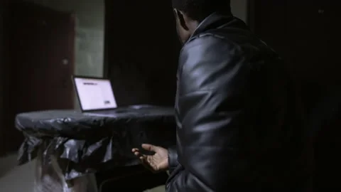 Caucasian guy and black guy are sitting near open laptop in a bomb shelter Stock-Footage 171348791