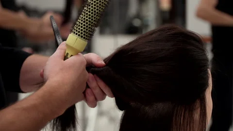 Caucasian guy in black clothes cuts the mannequin's hair Stock Footage 164060874