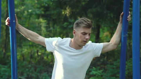 Caucasian guy doing exercises, stretching the shoulder joints Stock Footage 157070864