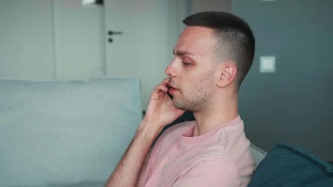 Caucasian guy freelancer sit on couch talk mobile phone at home smiling man Stock Footage 241745440