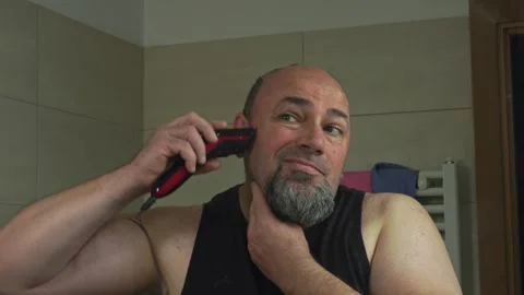 Caucasian Guy Shaving His Head Hair Alone in Bathroom Mirror Stock Footage 337164621
