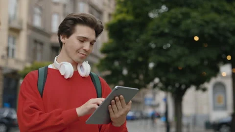 Caucasian Guy Standing on the Street Using Digital Tablet. Handsome Man User Stock Footage 256906047