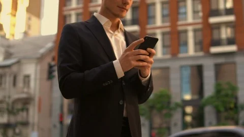 Caucasian guy use smart phone in city Stock Footage 90697531