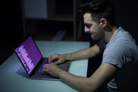 Caucasian hacker hacking the server in the dark Stock Photos