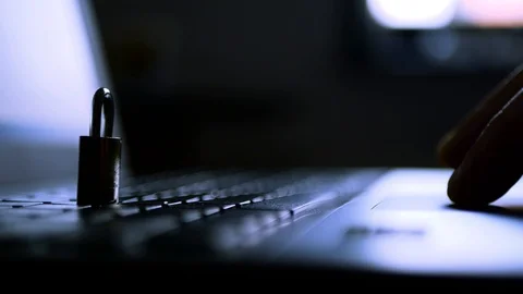Caucasian hacker operating on laptop computer in a dark room Stock Footage 113210955