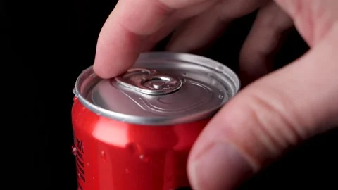 Caucasian hand opens a red soft drink can in slow motion, black background Stock Footage 171754313
