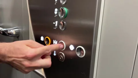 Caucasian hand rapidly pressing the close door button in an elevator. Stock Footage 248276757
