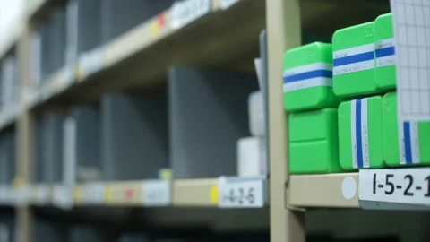 Caucasian Hand Takes Green Rectangle Object from Warehouse Shelving, Stock Footage 143347776