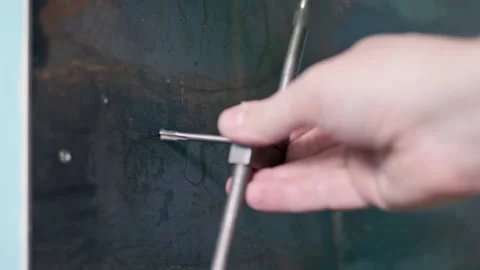 Caucasian hands hands cutting thread with a hand tap with a crank Stock Footage 170507090