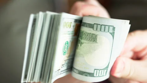Caucasian hands holding and checking a stack of hundred us dollar banknotes Stock Footage 267709562