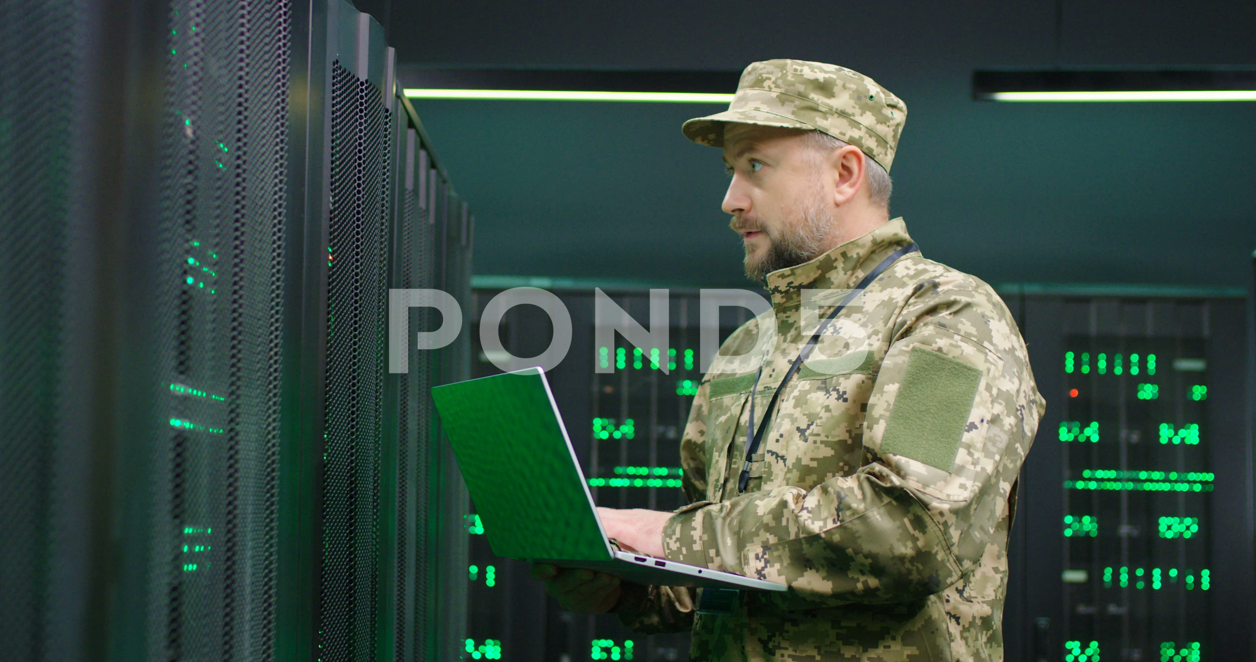 Caucasian handsome military man in uniform typing on keyboard of laptop  computer