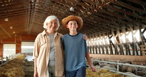 Caucasian happy old gray-haired grandmother walking with small cute teen boy in Stock Footage 139519210