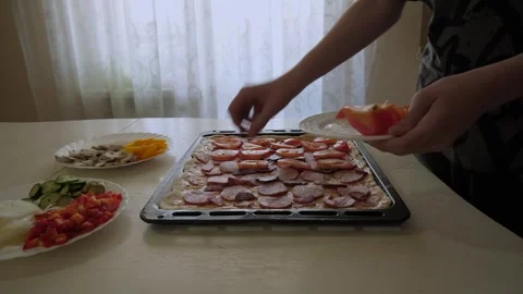 Caucasian home baker assembles a pizza Stock Footage 339973150
