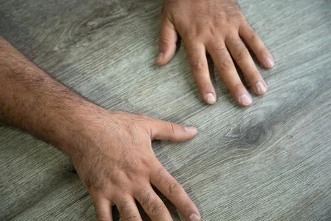 Caucasian human hand on the table. Stock Photos
