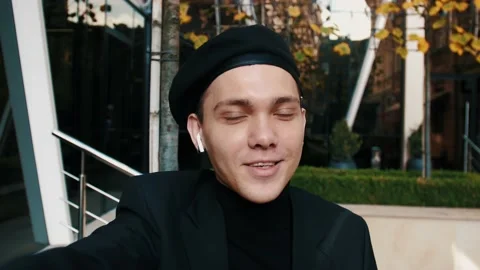 Caucasian influence holding camera for vlogging outside urban city, or doing Video stock 143862363
