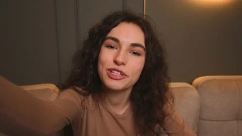 Caucasian influence holding camera for vlogging at home, or doing video call Video stock 155736948