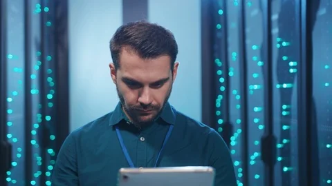 Caucasian IT engineer working on digital tablet in technological server room Stock Footage 119842453