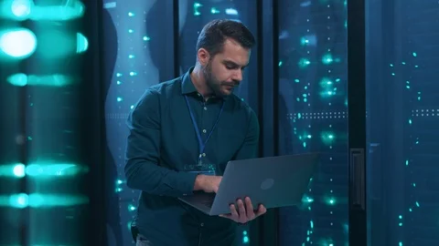 Caucasian IT professional admin using laptop computer doing data transfer Stock Footage 119841975