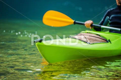 Caucasian Kayaker on the River Telephoto Closeup. Kayak Trip. Stock Photos