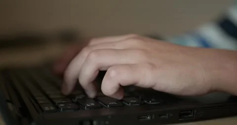 Caucasian kid hands type on keyboard. Boy use laptop computer. 4K 10-bit Stock Footage 345223182