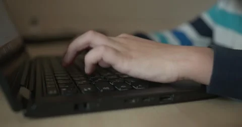Caucasian kid hands type on keyboard. Boy use laptop computer. 4K 10-bit Vídeo Stock 345223476