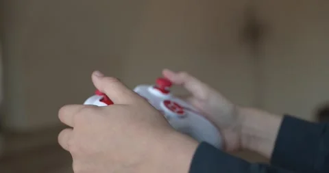 Caucasian kid hands use joystick remote controller. Boy play video game. 4K Stock Footage 345220553