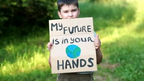 Caucasian kid looking to camera with My Future in Your Hands poster. save pla Stock Footage 134966421