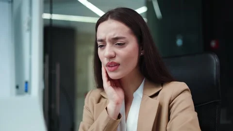 Caucasian lady having dental problem during working process on laptop at office Stock-Footage 258428984