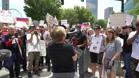 Caucasian lady using a megaphone during Atlanta's anti-gun protest Stock Footage 76836060