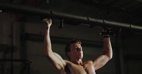 Caucasian male athlete does pull-ups Stock Footage 83323915