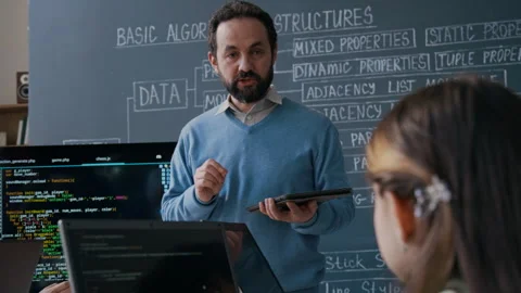 Caucasian Male Coding Teacher Explaining New Algorithm to Students Stock Footage 306935027
